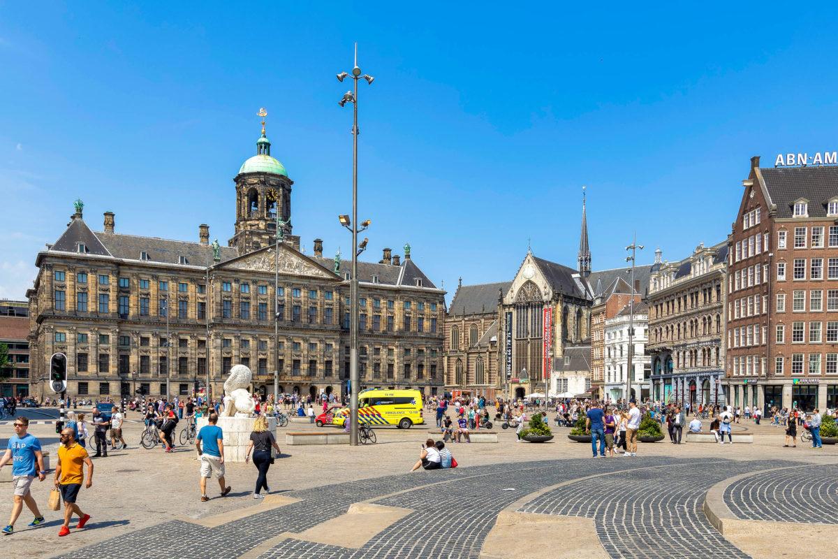 In the middle of downtown Amsterdam lies the busy Dam Square with the imposing Royal Palace, Netherlands - © Laszlo Szirtesi / Shutterstock